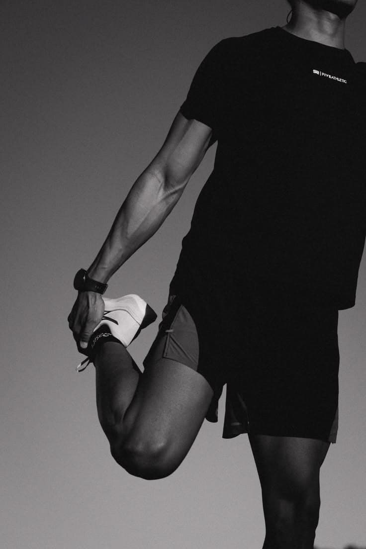 Close crop of an athlete holding a standing quad stretch
